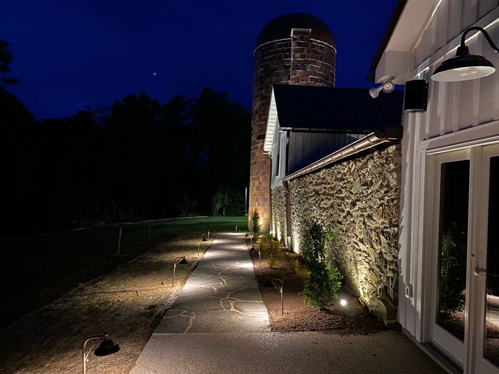 Side of barn house with path lights