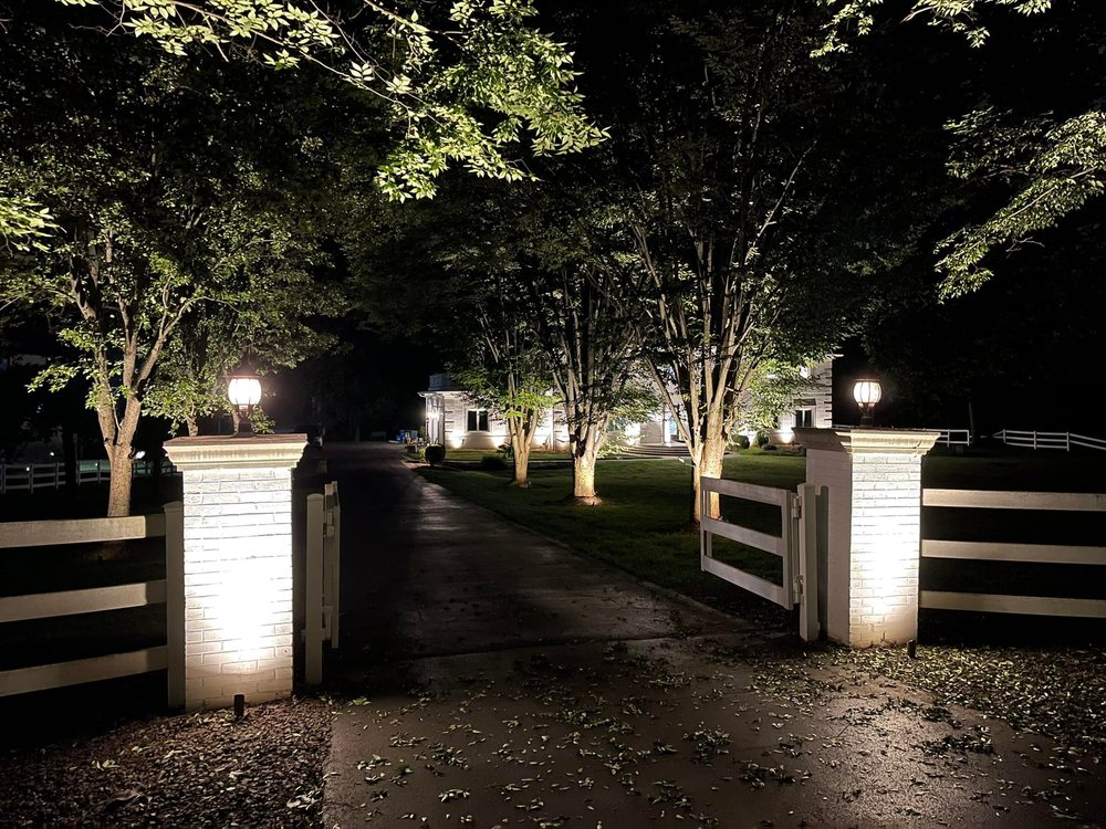 Opened gate of illuminated estate at night