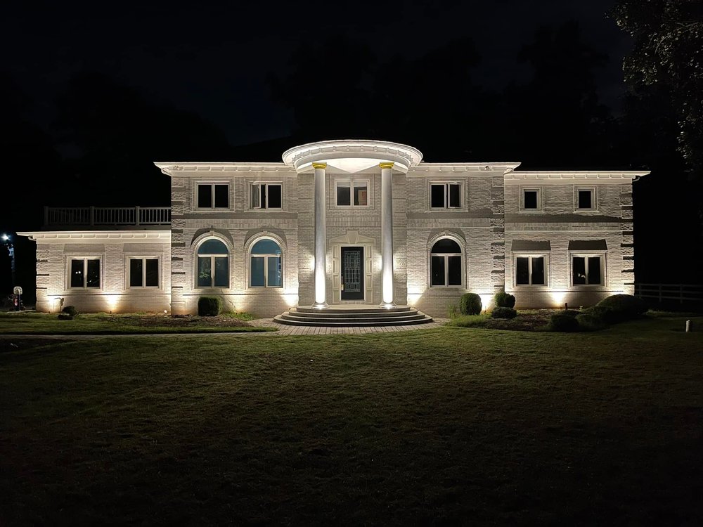 Front center view of illuminated estate at night